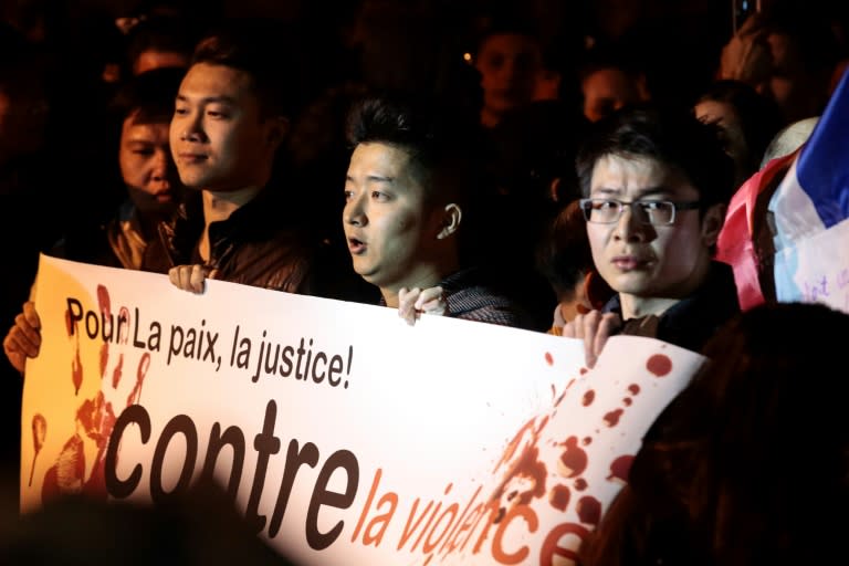 Protestors hold a banner reading "For peace and justice, against violence" at a demonstration after Paris police shoot a Chinese man, March 29, 2017