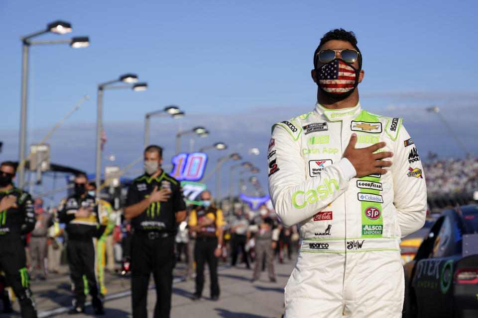 Bubba Wallace participates in the national anthem before a NASCAR Cup Series auto race Sunday, Sept. 6, 2020, in Darlington, S.C. (AP Photo/Chris Carlson)