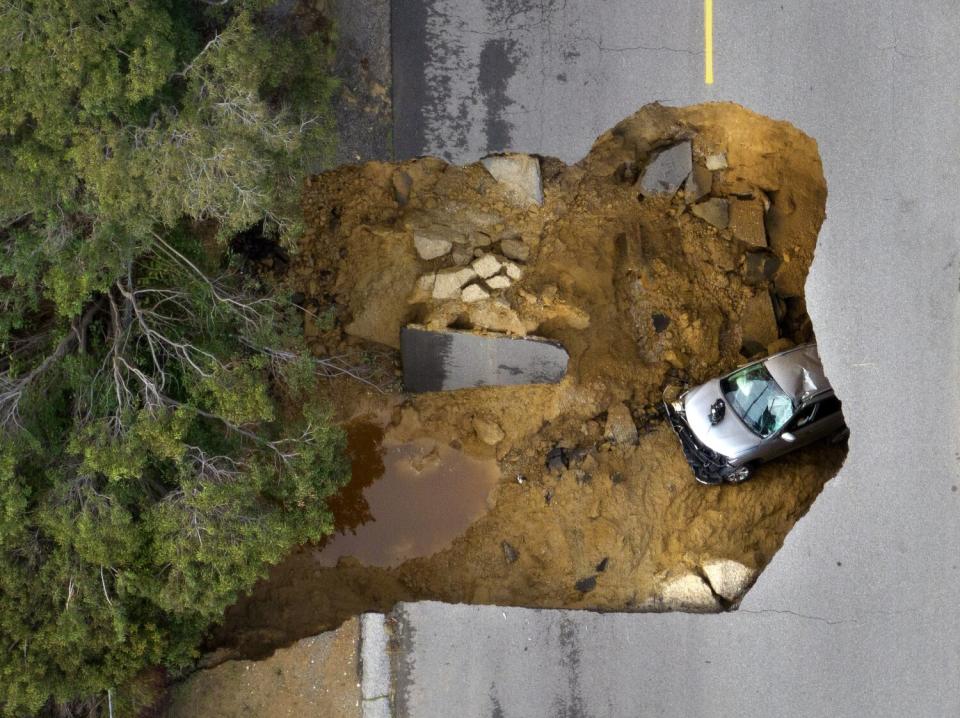 Two vehicles fell into a sinkhole on Iverson Road in Chatsworth, trapping four people on Tuesday.