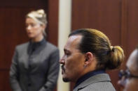 Actor Johnny Depp walks into the courtroom after a break at the Fairfax County Circuit Courthouse in Fairfax, Va., Monday, May 16, 2022. Depp sued his ex-wife Amber Heard for libel in Fairfax County Circuit Court after she wrote an op-ed piece in The Washington Post in 2018 referring to herself as a "public figure representing domestic abuse." (AP Photo/Steve Helber, Pool)