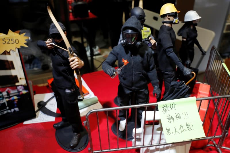 Figurines of black-clad protesters are see at a booth of independent fairs, selling protest-themed artwork, toys and accessories, ahead of Lunar New Year in Hong Kong