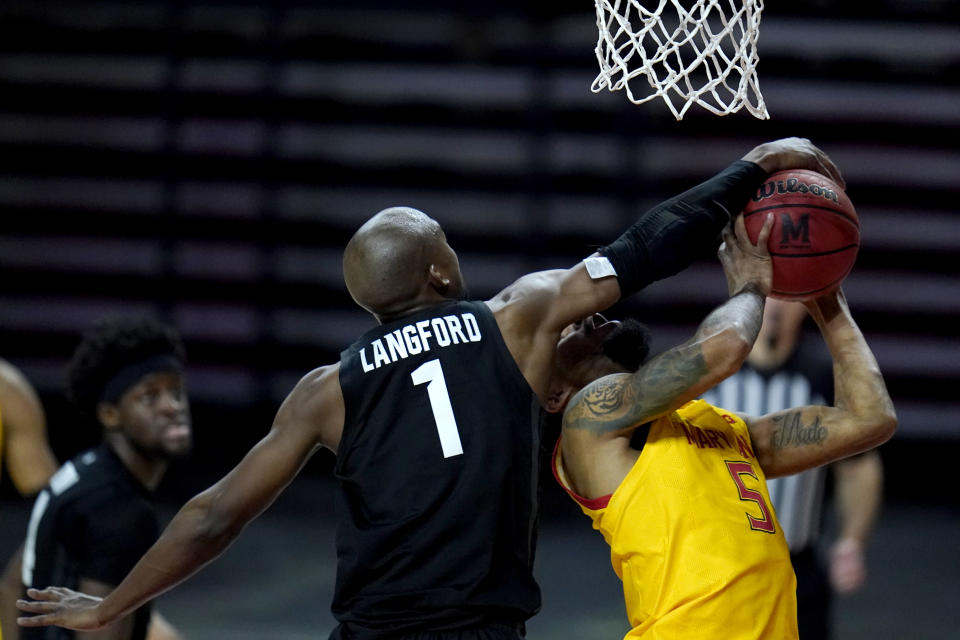 Maryland guard Eric Ayala, right, is fouled by Michigan State guard Joshua Langford during the second half of an NCAA college basketball game, Sunday, Feb. 28, 2021, in College Park, Md. Maryland won 73-55. (AP Photo/Julio Cortez)