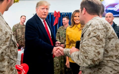 US President Donald Trump and First Lady Melania Trump greet members of the US military during an unannounced trip to Al Asad Air Base in Iraq on December 26, 2018. - Credit: SAUL LOEB / AFP