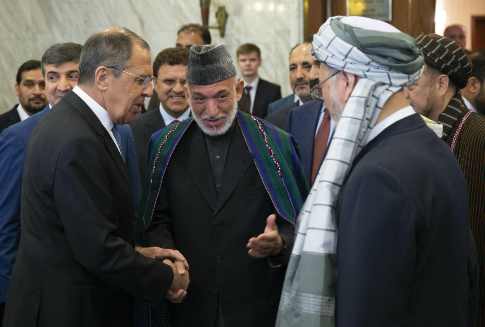 FILE - In this May 28, 2019 file photo, Former Afghan President Hamid Karzai, center, introduces the Taliban delegation to Russian Foreign Minister Sergey Lavrov, left, ahead of their meeting, in Moscow, Russia. Afghanistan’s Taliban leaders agreed they wanted a deal with the United States, but some among them were in more of a hurry than others. Even before U.S. President Donald Trump cancelled a mysterious Camp David summit on Saturday, Sept. 7, 2019, the Taliban negotiators were at odds with the council of leaders, or shura, that rules the Islamic movement. (AP Photo/Alexander Zemlianichenko)