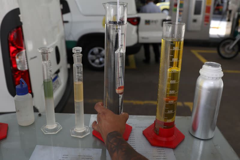 A worker of National Petroleum Agency ANP, makes a procedure to check fuel quality at a gas station in Rio de Janeiro
