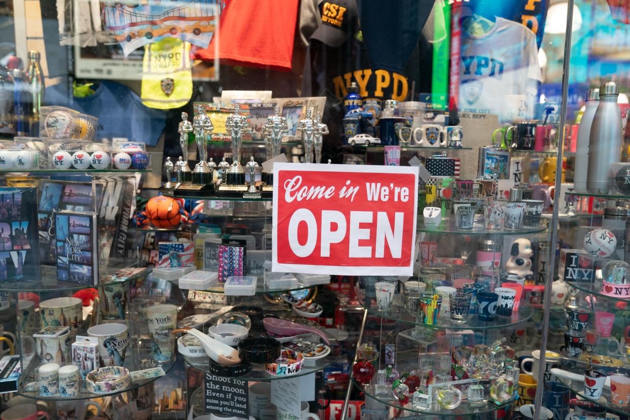 An open sign in the window of a gift shop is seen in Times Square on August 16, 2020 in New York. - Five months after New York City shut down to combat the coronavirus, the tourism industry remains flat. Business leaders and City officials are trying to devise plans to revive the tourism industry that has in years past brought in $45 billion annually and supported 300,000 jobs. (Photo by Bryan R. Smith / AFP) (Photo by BRYAN R. SMITH/AFP via Getty Images)