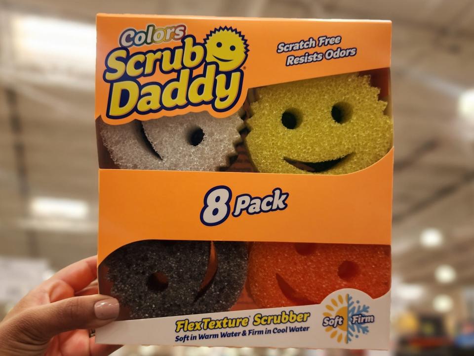 Box of eight yellow, white, black, and red Scrub Daddy sponges