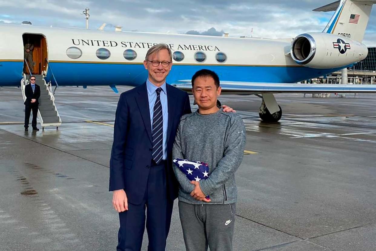 Xiyue Wang, right, with Brian Hook, the US representative for Iran, at an airport in Zurich, Switzerland, following his release from jail in Iran as part of a prisoner swap: AP