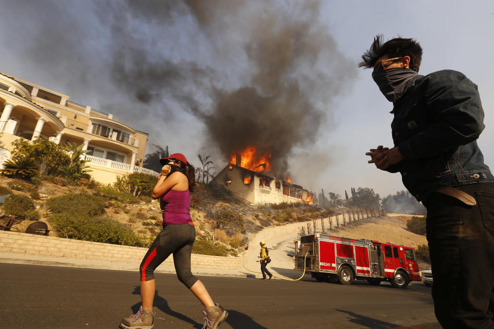 Amanda Leon and her husband, Johnny Leon, watch as firefighters fight to save homes in Ventura County.