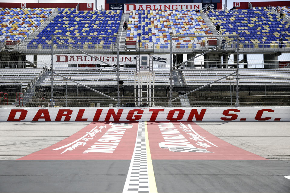 FILE - In this May 17, 2020, file photo, the grandstands are empty at Darlington Raceway before a NASCAR Cup Series auto race in Darlington, S.C. Darlington Raceway officials are excited about hosting the first of two scheduled NASCAR weekends, something the track hadn’t featured since 2004. (AP Photo/Brynn Anderson, File)