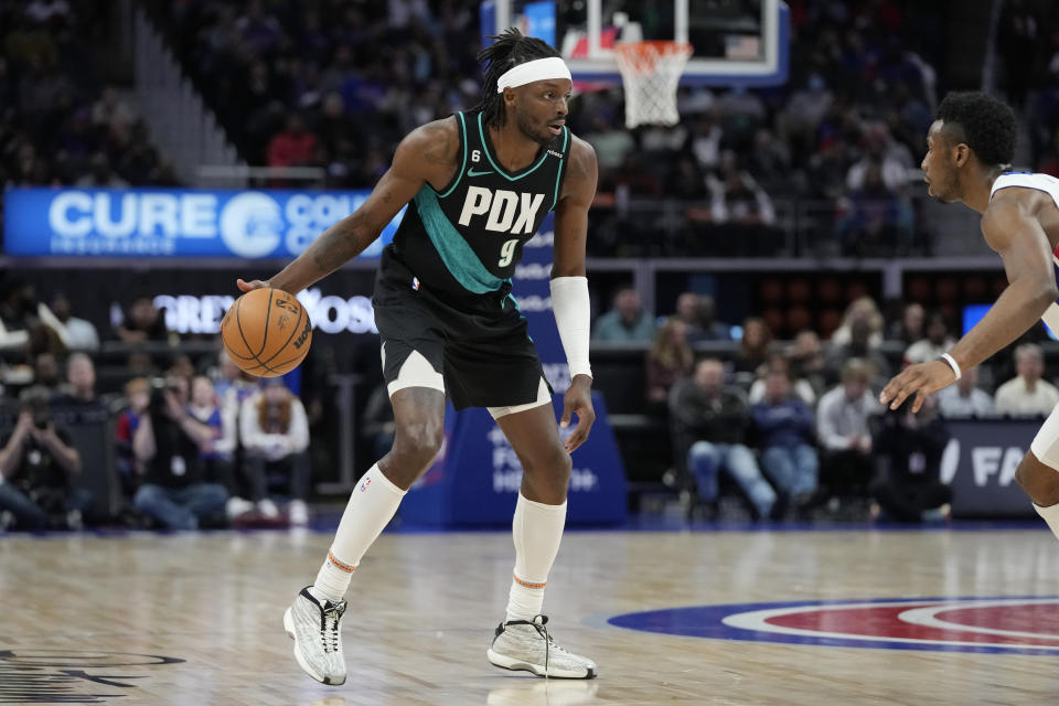 Portland Trail Blazers forward Jerami Grant (9) brings the ball up court during the first half of an NBA basketball game against the Detroit Pistons, Monday, March 6, 2023, in Detroit. (AP Photo/Carlos Osorio)