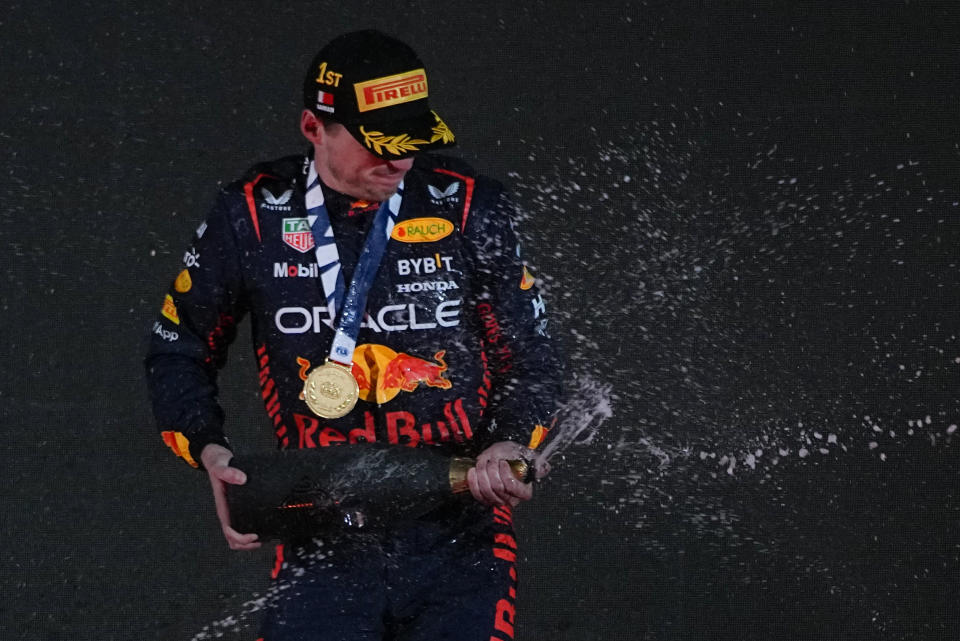 Red Bull driver Max Verstappen of the Netherlands celebrates on the podium after wining the Formula One Bahrain Grand Prix at Sakhir circuit, Sunday, March 5, 2023. (AP Photo/Ariel Schalit)