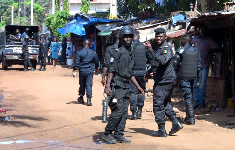 Police officers deploy outside a court in Conakry