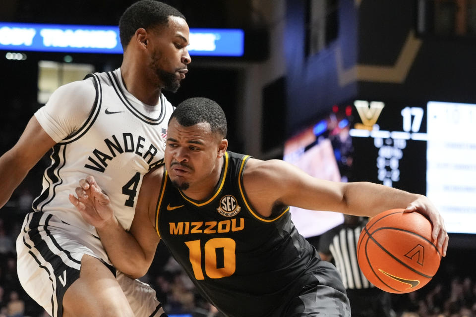 Missouri guard Nick Honor (10) tries to get past Vanderbilt guard Isaiah West (4) during the first half of an NCAA college basketball game Saturday, Feb. 3, 2024, in Nashville, Tenn. (AP Photo/George Walker IV)