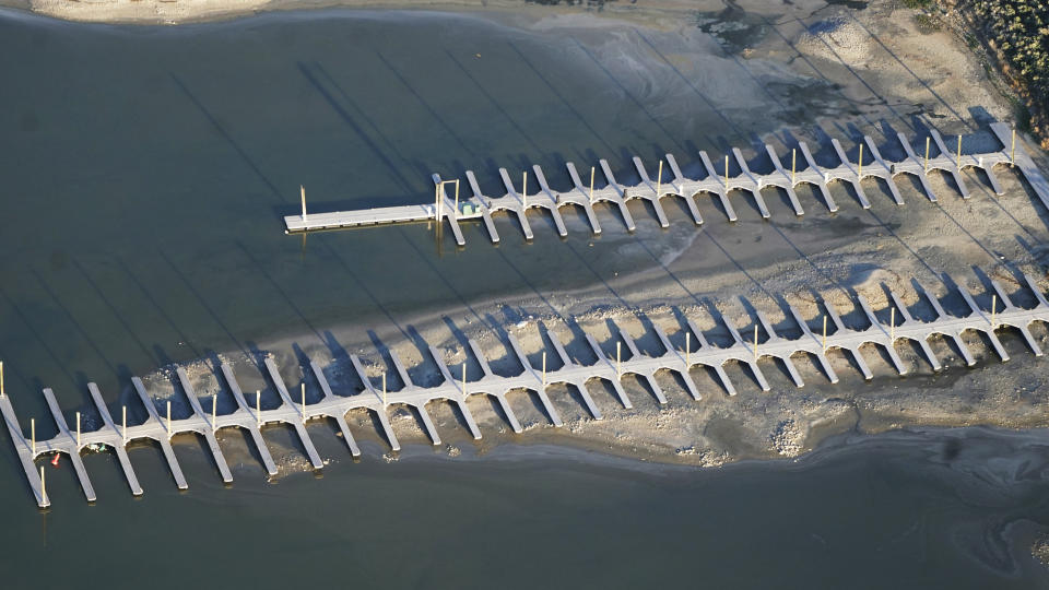 FILE - The shallow water is seen from above at a boat dock on May 13, 2021, at Antelope Island, Utah. The water levels at the Great Salt Lake have hit a historic low, a grim milestone for the largest natural lake west of the Mississippi River that comes as a megadrought grips the region. (AP Photo/Rick Bowmer, File)