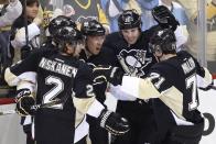 Pittsburgh Penguins' Jussi Jokinen (36) celebrates his goal with teammates in the first period of a first-round NHL playoff hockey game against the Columbus Blue Jackets in Pittsburgh on Wednesday, April 16, 2014. (AP Photo/Gene J. Puskar)