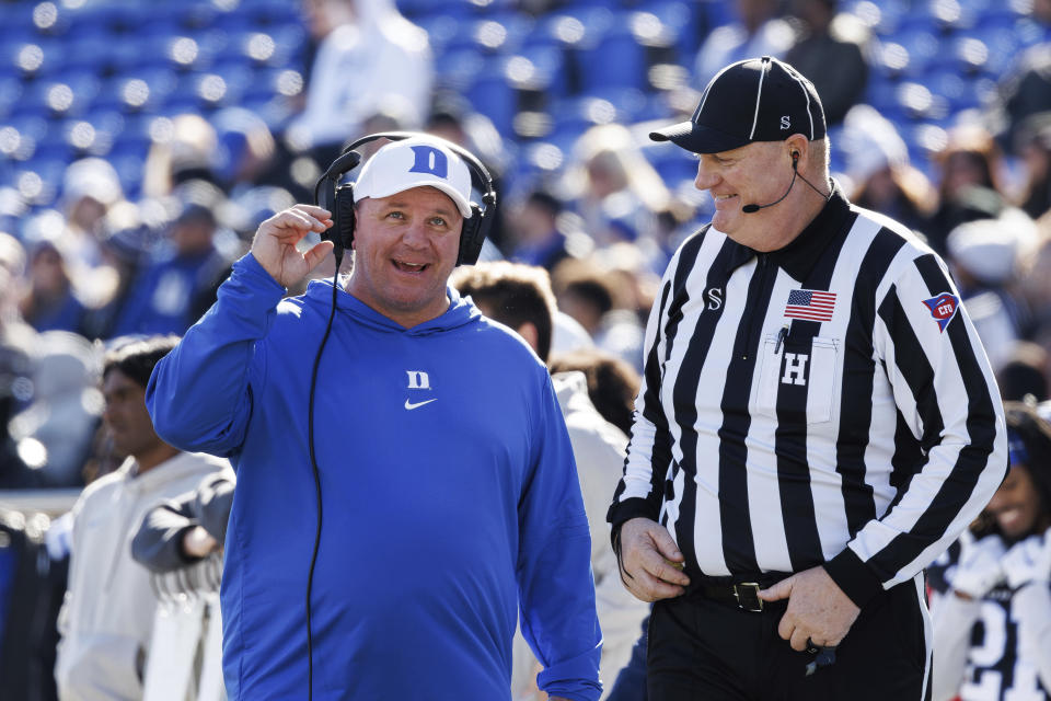 Duke head coach Mike Elko smiles with an official during the first half of an NCAA college football game against Pittsburgh in Durham, N.C., Saturday, Nov. 25, 2023. (AP Photo/Ben McKeown)