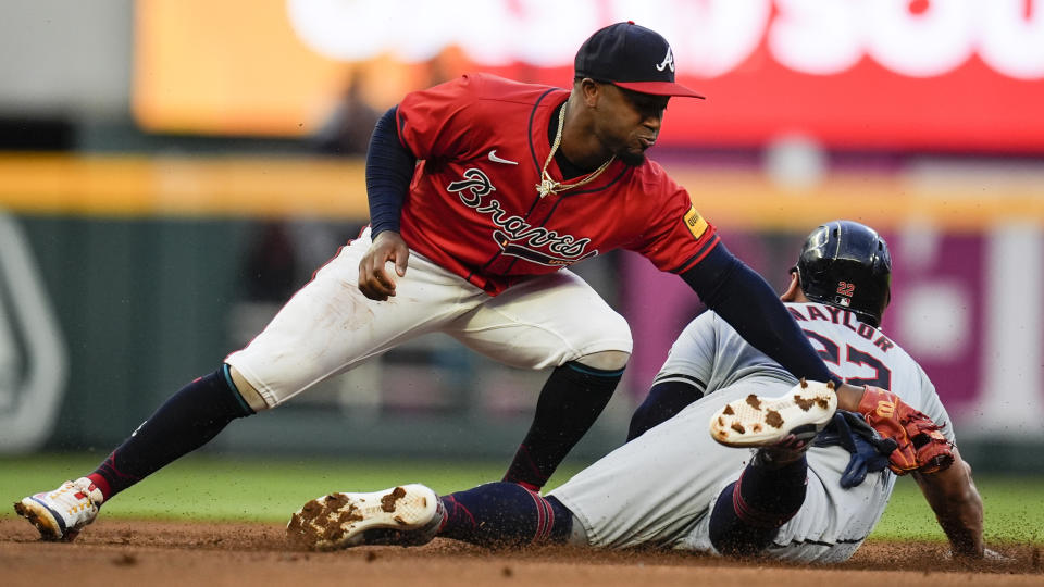 Cleveland guardians’ Josh Naylor steals second base as Atlanta Braves second baseman Ozzie Albies applies the late tag during the first inning of a baseball game, Friday, April 26, 2024, in Atlanta. (AP Photo/Mike Stewart)