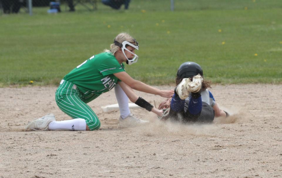 Mendon shortstop Jaydn Samson tags out a Cassopolis runner attempting to steal second base on Saturday.