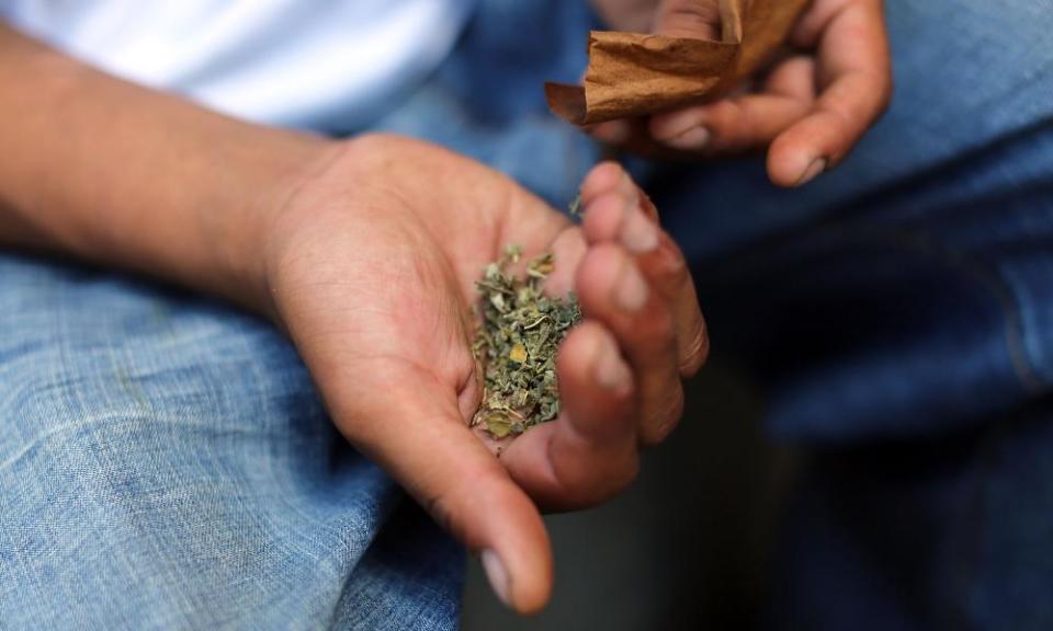 A man prepares to smoke K2 on 5 August 2015 in New York City.