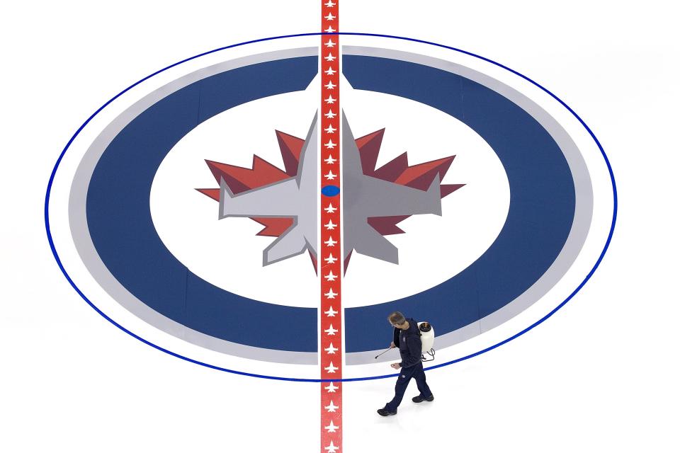 WINNIPEG, CANADA - JANUARY 8: Ice technicians install the Winnipeg Jets logo at centre ice at the MTS Centre on January 8, 2013 in Winnipeg, Manitoba, Canada. (Photo by Marianne Helm/Getty Images)