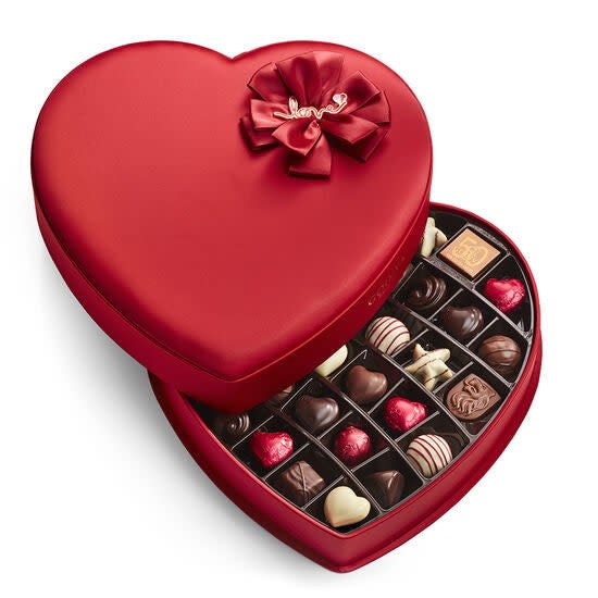 <strong><h3><h2>Godiva</h2></h3></strong><br>It's never a bad idea to fall back on reliable-sweet classics during stressful Valentine's Day gift shopping — and Godiva's bundles of adorably packaged truffles to chocolate-covered pretzels and hot-cocoa mix hits the easily-deliverable mark. <br><br><em>Shop </em><strong><em><a href="https://www.godiva.com/valentines-day-gifts" rel="nofollow noopener" target="_blank" data-ylk="slk:Godiva" class="link ">Godiva</a></em></strong><br><br><strong>Godiva</strong> Valentine's Day Fabric Heart Chocolate Gift Box, $, available at <a href="https://go.skimresources.com/?id=30283X879131&url=https%3A%2F%2Fwww.godiva.com%2Fvalentines-day-fabric-heart-chocolate-gift-box%2FFABRICHEARTS.html" rel="nofollow noopener" target="_blank" data-ylk="slk:Godiva" class="link ">Godiva</a>