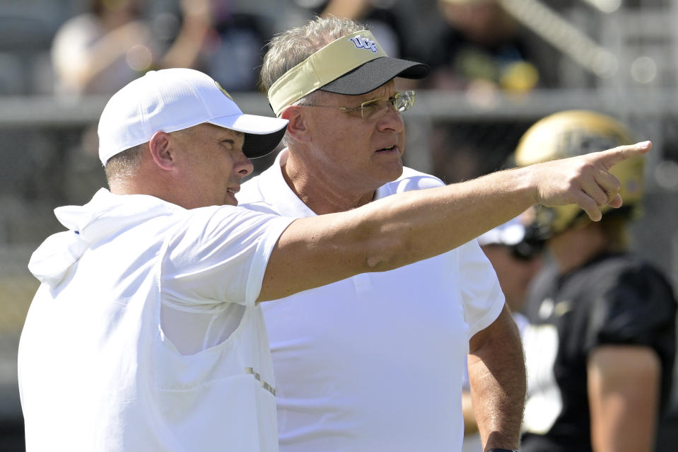 Georgia Tech head coach Geoff Collins, left, and Central Florida head coach Gus Malzahn chat on the field before an NCAA college football game, Saturday, Sept. 24, 2022, in Orlando, Fla. (AP Photo/Phelan M. Ebenhack)