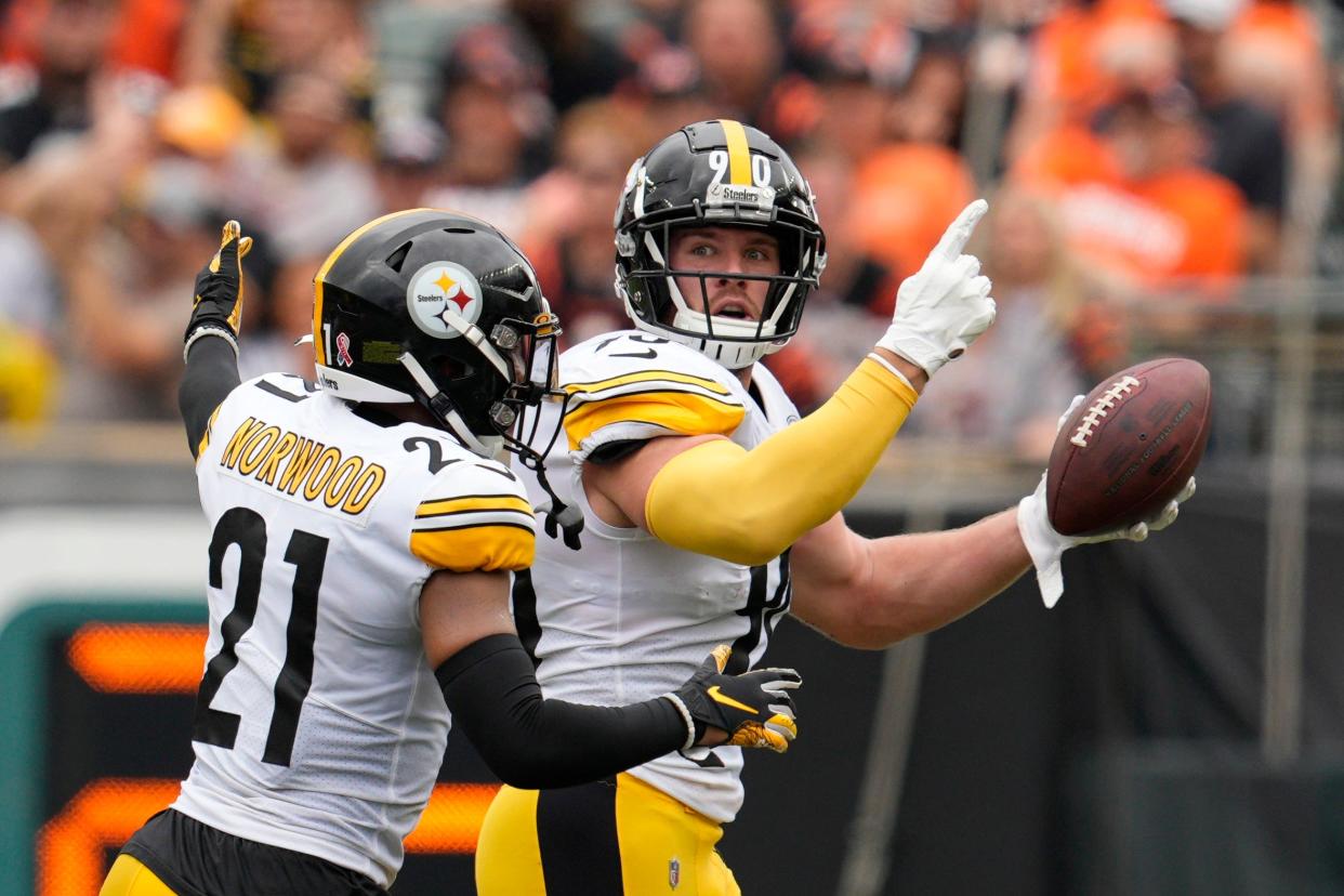 Pittsburgh Steelers linebacker T.J. Watt (90) celebrates after an interception with safety Tre Norwood (21) during the first half of an NFL football game against the Cincinnati Bengals, Sunday, Sept. 11, 2022, in Cincinnati.