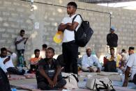 Ethiopian migrants rest before they were flown back to Ethiopia, at an IOM shelter in Aden