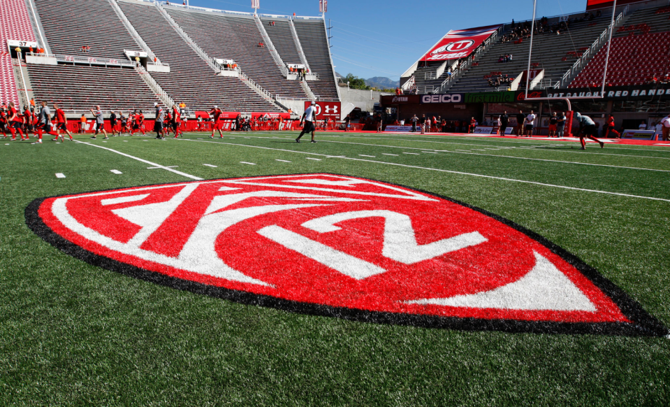 Pac-12 logo on a grass field.