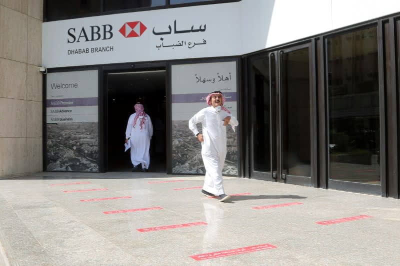 Saudi men are seen at SABB bank as the government eases lockdown restrictions amid the coronavirus disease (COVID-19) outbreak, in Riyadh