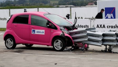 A Mitsubishi i-MiEV electric car collides with crash cushions in a controlled crash test from insurer AXA in Duebendorf