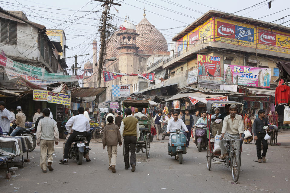 Agra, Uttar Pradesh, India, South Asia. Shoppers and stalls at Kinari bazaar. The Jama Masjid mosque in the background dates from 1648