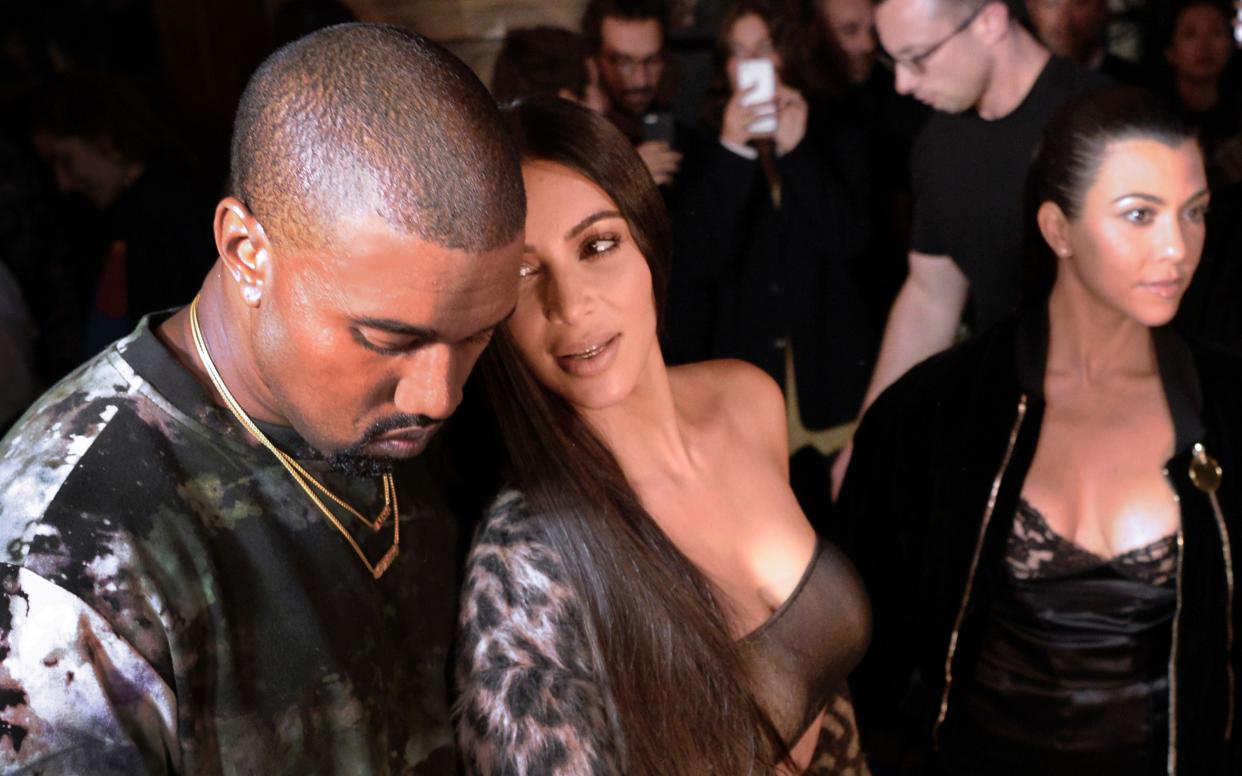 This file photo taken on September 29, 2016 shows (From L) Kanye West, Kim Kardashian and Kourtney Kardashian attending the Off-white 2017 Spring/Summer ready-to-wear collection fashion show in Paris - AFP or licensors