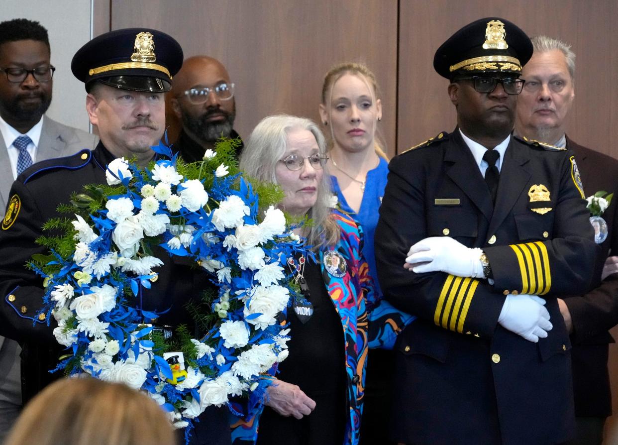 Patty Jerving (center) the mother of Peter Jerving, who was fatally shot on February 7, 2023, while attempting to arrest a robbery suspect, takes part in the memorial wreath presentation ceremony, escorted by Milwaukee Sgt. Paul Graczyk, and Milwaukee Police Chief Jeffrey Norman as part of the annual Greater Milwaukee Law Enforcement Memorial Ceremony at the Milwaukee County War Memorial Center in Milwaukee on Thursday, May 9, 2024.
