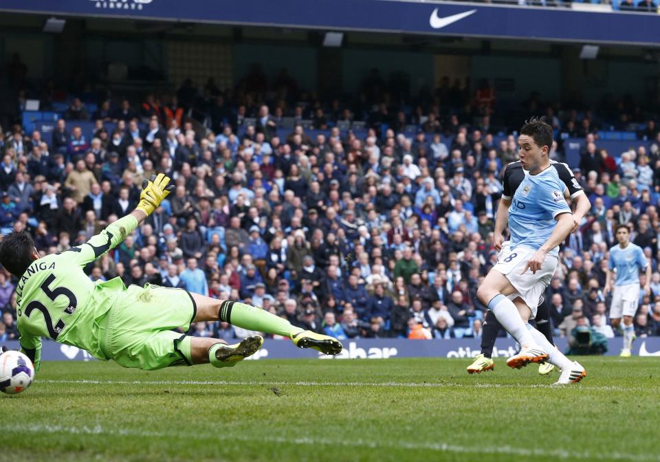 Manchester City's Samir Nasri (R) scores a goal during their English Premier League soccer match against Southampton at the Etihad stadium in Manchester, northern England April 5, 2014. REUTERS/Darren Staples (BRITAIN - Tags: SPORT SOCCER) FOR EDITORIAL USE ONLY. NOT FOR SALE FOR MARKETING OR ADVERTISING CAMPAIGNS. NO USE WITH UNAUTHORIZED AUDIO, VIDEO, DATA, FIXTURE LISTS, CLUB/LEAGUE LOGOS OR "LIVE" SERVICES. ONLINE IN-MATCH USE LIMITED TO 45 IMAGES, NO VIDEO EMULATION. NO USE IN BETTING, GAMES OR SINGLE CLUB/LEAGUE/PLAYER PUBLICATIONS