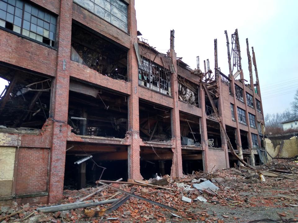 Only the brick frame remains Saturday on the Johnston Street side of the former Goodyear Tire & Rubber Co. mixing center in Akron.