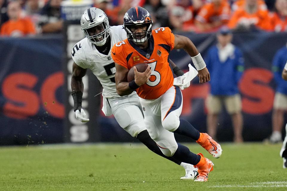 Denver Broncos quarterback Russell Wilson (3) runs the ball under pressure from Las Vegas Raiders linebacker Divine Deablo (5) during the second half of an NFL football game, Sunday, Sept. 10, 2023, in Denver. (AP Photo/Jack Dempsey)