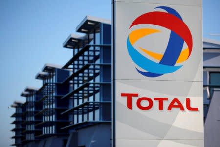 FILE PHOTO: The logo of French oil giant Total is seen in front of the oil refinery of Donges, near Nantes, France, December 20, 2013.    REUTERS/Stephane Mahe/File Photo