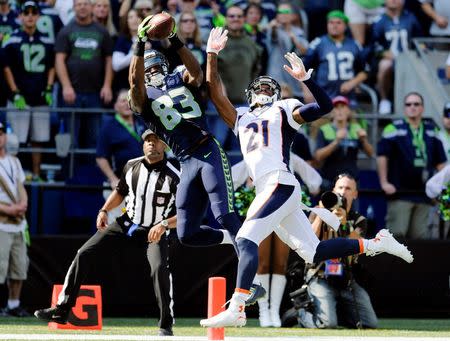 Seattle Seahawks wide receiver Ricardo Lockette (83) catches a touchdown pass over Denver Broncos cornerback Aqib Talib (21) during the first half at CenturyLink Field. Mandatory Credit: Steven Bisig-USA TODAY Sports