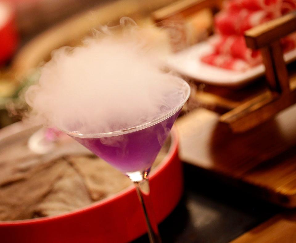 A smoking purple romantic martini is on the menu at Wei Shu Wu Hot Pot.
