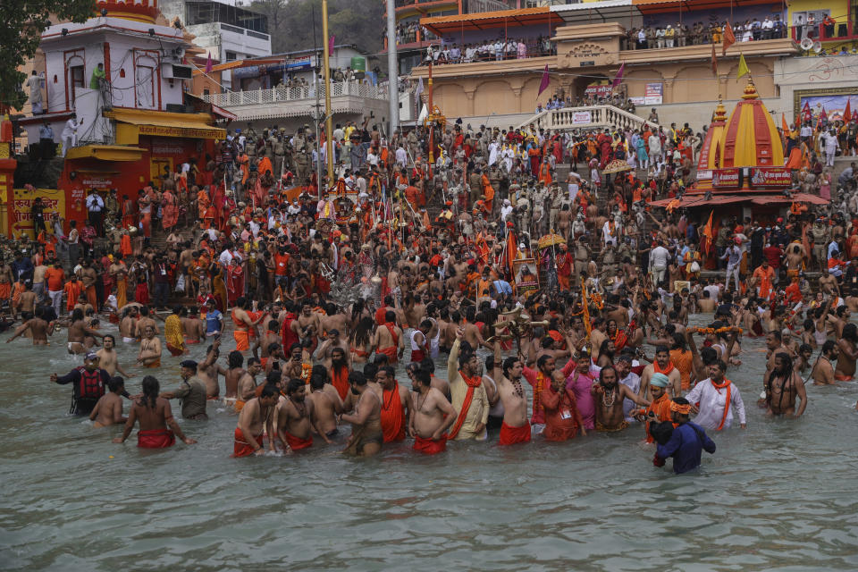 Devotees  take holy dips in the Ganges River during Kumbh Mela, or pitcher festival, one of the most sacred pilgrimages in Hinduism, in Haridwar, northern state of Uttarakhand, India, Monday, April 12, 2021. India is experiencing its worst pandemic surge, with average daily infections exceeding 130,000 over the past week. The federal government has allowed huge gatherings during Hindu festivals like the Kumbh Mela where millions of devotees daily take a holy dip into the Ganges river. In response to concerns that it could turn into a “superspreader” event, the state's chief minister, Tirath Singh Rawat, said “the faith in God will overcome the fear of the virus.