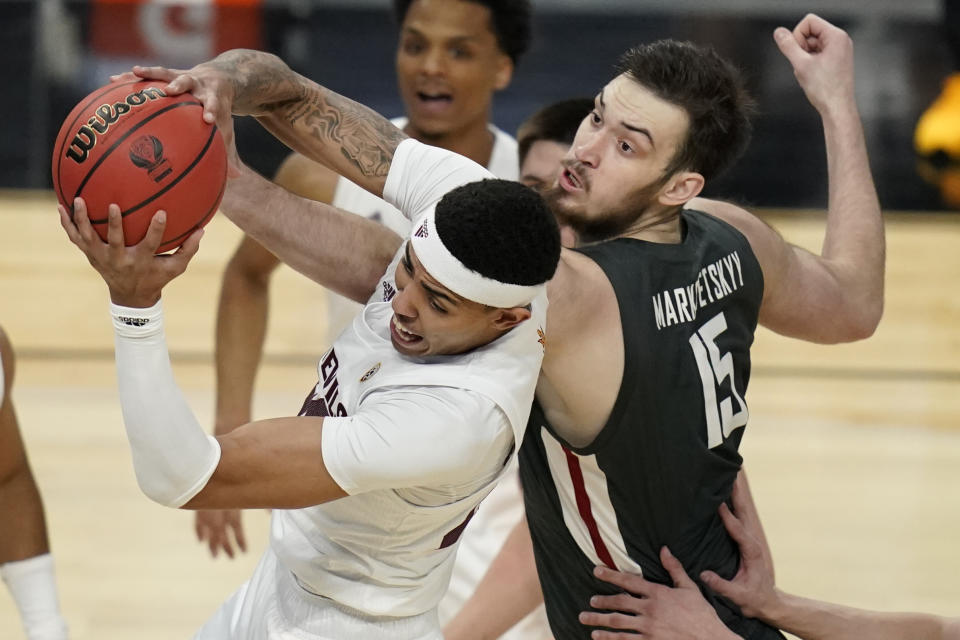 Arizona State's Jalen Graham, left, grabs a rebound over Washington State's Volodymyr Markovetskyy (15) during the first half of an NCAA college basketball game in the first round of the Pac-12 men's tournament Wednesday, March 10, 2021, in Las Vegas. (AP Photo/John Locher)