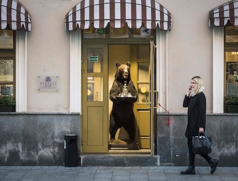 A stuffed bear proffers vodka at a shop in Moscow - Credit: GETTY