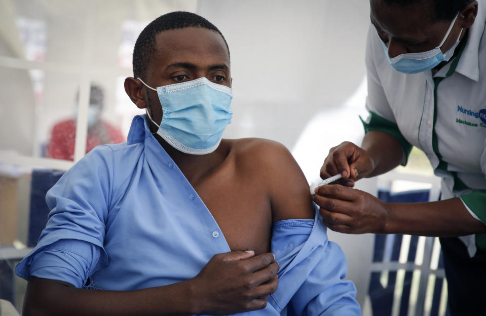 A frontline worker receives a shot of the AstraZeneca COVID-19 vaccine, manufactured by the Serum Institute of India and provided through the global COVAX initiative, in Machakos, Kenya, Wednesday, March 24, 2021. AstraZeneca's repeated missteps in reporting vaccine data coupled with a blood clot scare could do lasting damage to the credibility of a shot that is the linchpin in the global strategy to stop the coronavirus pandemic, potentially even undermining vaccine confidence more broadly, experts say. (AP Photo/Brian Inganga)