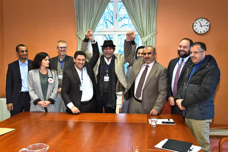 At left, Abdelqader al-Murtada and Saelem Mohammed Noman Al-Mughalles, representatives of the Ansar Allah delegation and at right, Askar Zaeil and Hadi al-Hayi representing the delegation of the Government of Yemen gesture at the negotiating table together with representatives from the office of the U.N. Special Envoy for Yemen and the International Red Cross Committee (ICRC) after lists of prisoners were exchanged, a first step to implement the agreement to release all prisoners by the two parties, during the ongoing peace talks on Yemen held at Johannesberg Castle, in Rimbo, near Stockholm, Sweden, December 11, 2018. TT News Agency/Claudio Bresciani via REUTERS