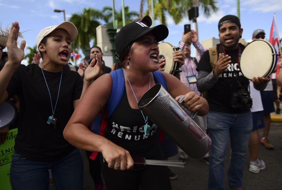 FILE - In this July 22, 2019 file photo, demonstrators play on percussion instruments as they march on Las Americas highway demanding the resignation of governor Ricardo Rossello, in San Juan, Puerto Rico. Puerto Ricans are now asking themselves what comes after Gov. Ricardo Rossello announced his resignation after having achieved their main goal: ousting a governor for the first time in the U.S. territory's recent history. (AP Photo/Carlos Giusti, File)