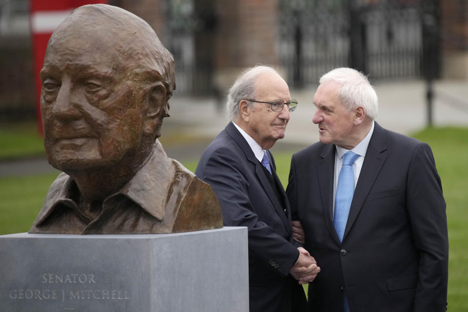 Former U.S. Sen. George Mitchell, shakes hands with Bertie Ahern during g a bust unveiling on the first day of a three-day international conference at Queen's University Belfast to mark the 25th anniversary of the Good Friday Agreement, in Belfast, Northern Ireland, Monday, April 17, 2023. Former U.S. President Bill Clinton and past leaders of the U.K. and Ireland are gathering in Belfast on Monday, 25 years after their charm, clout and determination helped Northern Ireland strike a historic peace accord. (AP Photo/Christophe Ena)