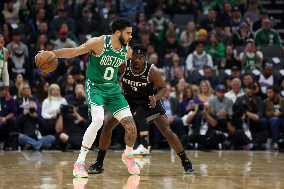 <a class="link " href="https://sports.yahoo.com/nba/players/5765" data-i13n="sec:content-canvas;subsec:anchor_text;elm:context_link" data-ylk="slk:Jayson Tatum;sec:content-canvas;subsec:anchor_text;elm:context_link;itc:0">Jayson Tatum</a> #0 of the Boston Celtics is guarded by Terence Davis #3 of the <a class="link " href="https://sports.yahoo.com/nba/teams/sacramento/" data-i13n="sec:content-canvas;subsec:anchor_text;elm:context_link" data-ylk="slk:Sacramento Kings;sec:content-canvas;subsec:anchor_text;elm:context_link;itc:0">Sacramento Kings</a> in the first half at Golden 1 Center on March 21, 2023, in Sacramento, California. (Ezra Shaw/Getty Images)