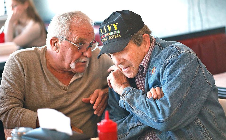 U.S. Navy veterans Paul Landry, left, and Steve Pineault, right, who both served in Vietnam, catch up before lunch at The Hop in Brant Rock on Jan. 10.